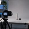 Tabletop product demonstration filming setup with camera and softbox lights