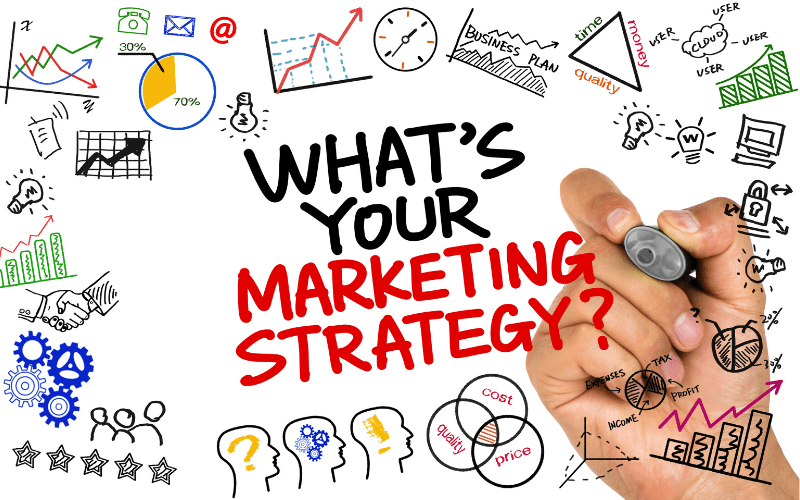 A hand holding a marker writes on a whiteboard, the words "What's your marketing strategy?" are legible in blue ink against the white background. The image represents the concept of whiteboard explainer videos