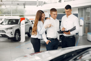 Stylish and elegant couple in a car salon