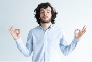 stay calm - man against white background meditating with collared shirt