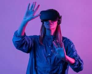 Woman wearing vr glasses with purple light